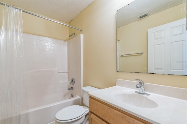 full bathroom featuring toilet, a textured ceiling, shower / tub combo with curtain, and vanity