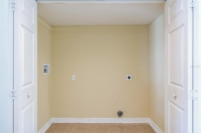 laundry area with hookup for an electric dryer, hookup for a washing machine, and light tile patterned floors