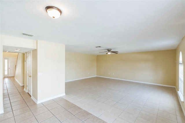 spare room featuring ceiling fan and light tile patterned floors