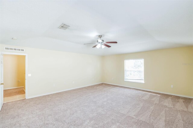 carpeted empty room with ceiling fan and lofted ceiling