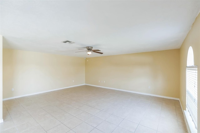 unfurnished room with ceiling fan and light tile patterned floors