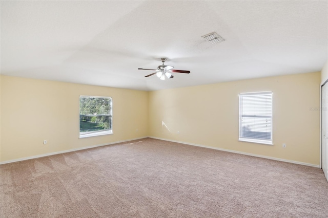 unfurnished room featuring light carpet and ceiling fan