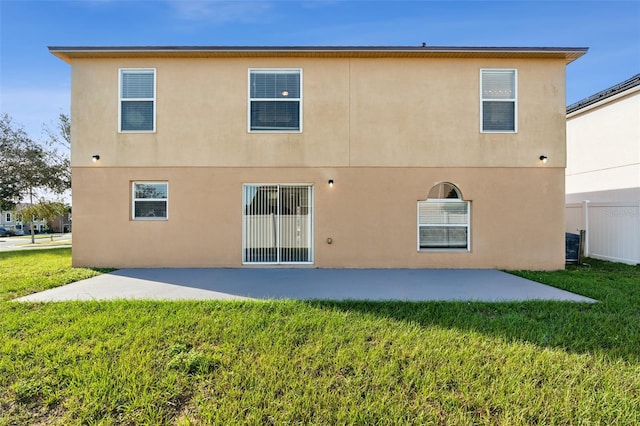 back of house featuring a patio area and a yard