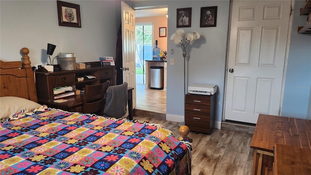 bedroom with dark wood-type flooring