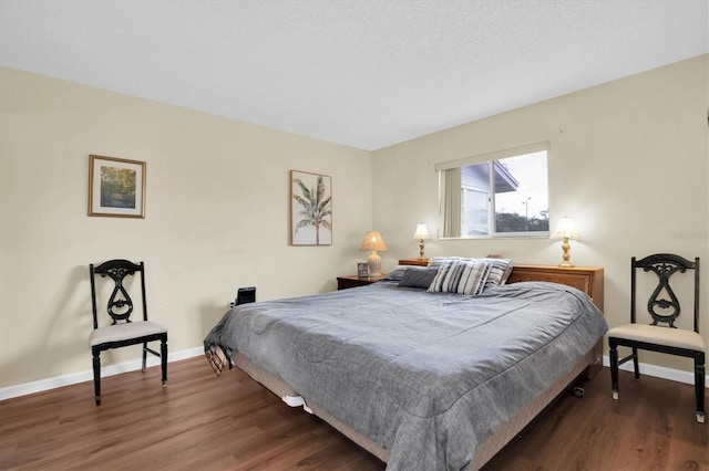 bedroom with dark wood-type flooring