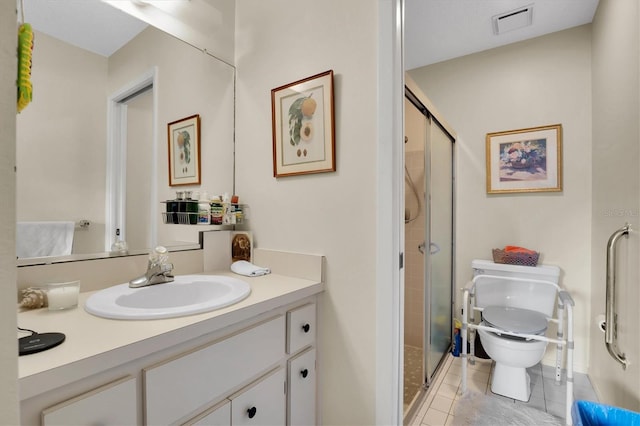 bathroom with tile patterned floors, vanity, toilet, and an enclosed shower