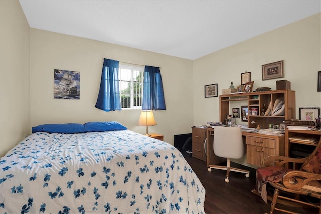 bedroom with dark hardwood / wood-style flooring