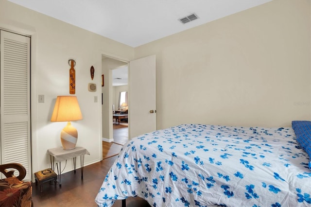 bedroom with a closet and dark wood-type flooring