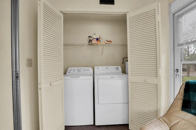 laundry room featuring washer and clothes dryer and carpet