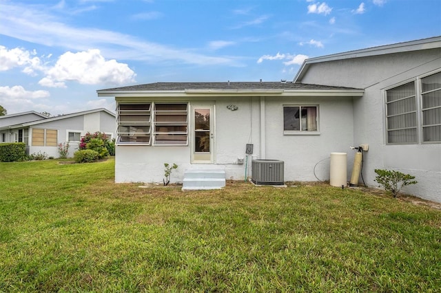 exterior space with a lawn and central AC unit