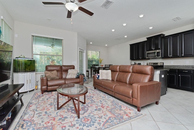 tiled living room with ceiling fan