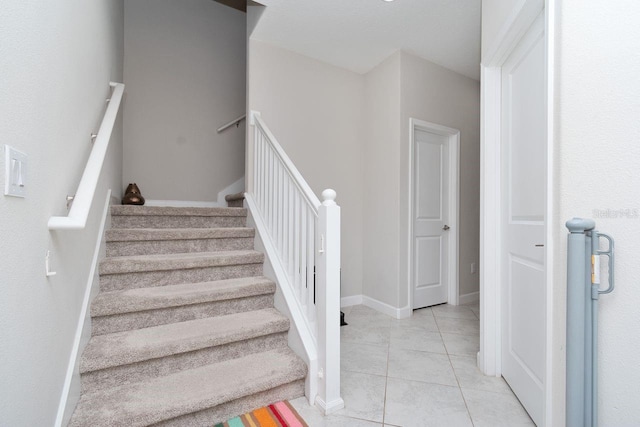 stairs with tile patterned flooring