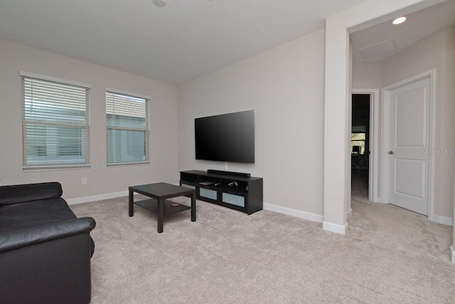 carpeted living room with a textured ceiling