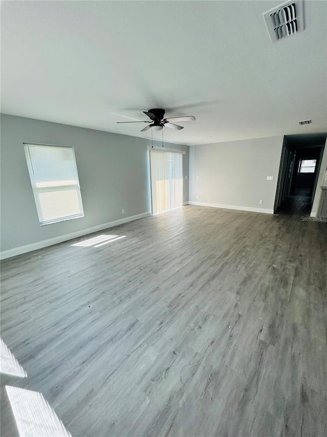 unfurnished living room with wood-type flooring and ceiling fan