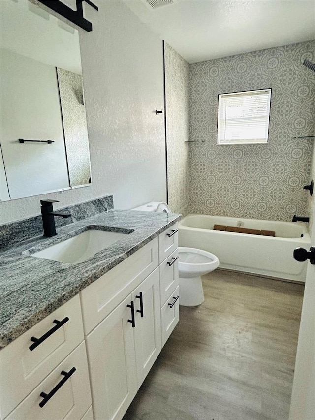 full bathroom with vanity, hardwood / wood-style floors, toilet, and tub / shower combination