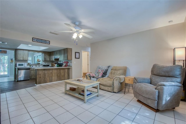 tiled living room with sink and ceiling fan