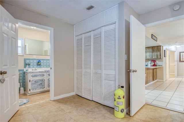 hallway with light tile patterned floors