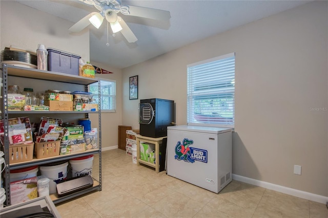 interior space with ceiling fan