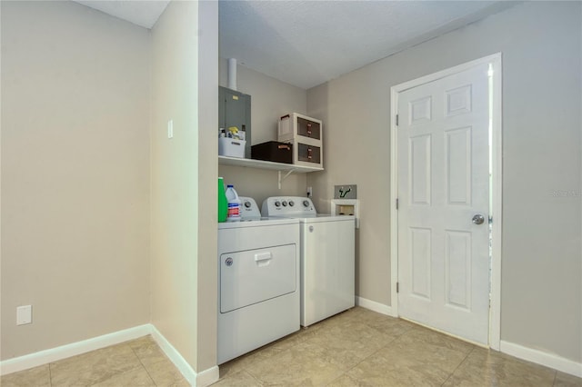 laundry area with independent washer and dryer, a textured ceiling, and light tile patterned floors