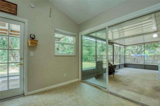 doorway to outside featuring lofted ceiling