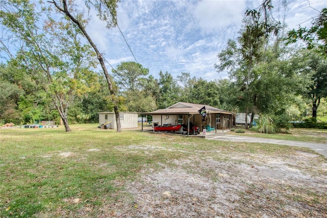 view of yard with a storage shed and a carport