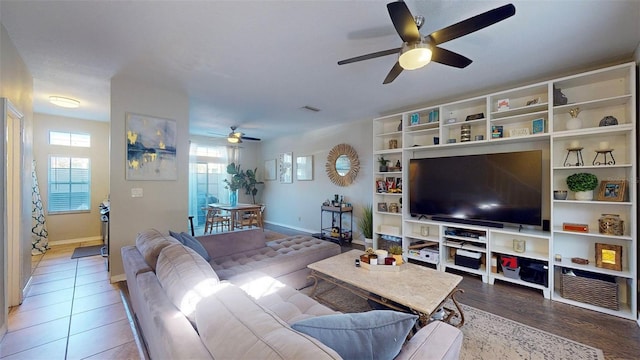 living room featuring hardwood / wood-style floors, ceiling fan, and a wealth of natural light