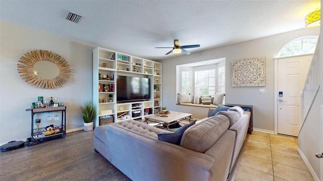 living room with ceiling fan and wood-type flooring