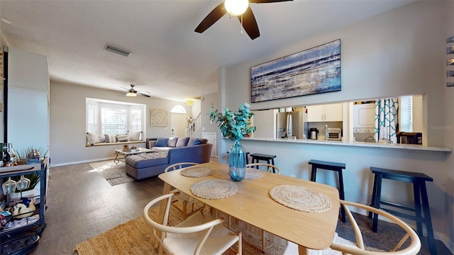 dining room with dark hardwood / wood-style floors and ceiling fan