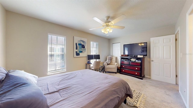 carpeted bedroom featuring a textured ceiling, a closet, and ceiling fan