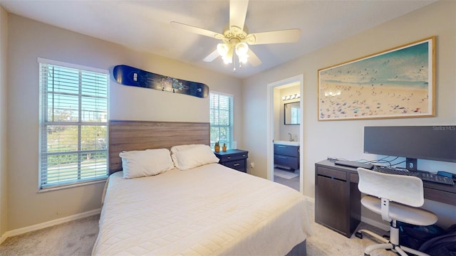 carpeted bedroom featuring connected bathroom and ceiling fan