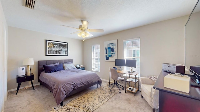 bedroom with light carpet, a textured ceiling, and ceiling fan