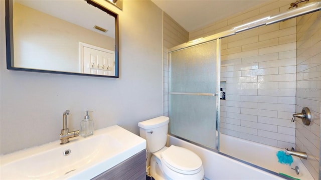 full bathroom featuring vanity, toilet, and combined bath / shower with glass door