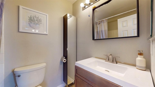 bathroom featuring vanity, a shower with curtain, and toilet