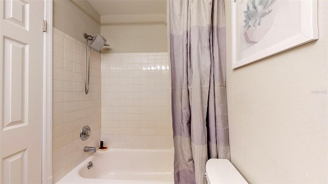 bathroom featuring shower / tub combo with curtain and toilet