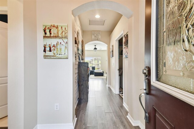 corridor with dark hardwood / wood-style flooring