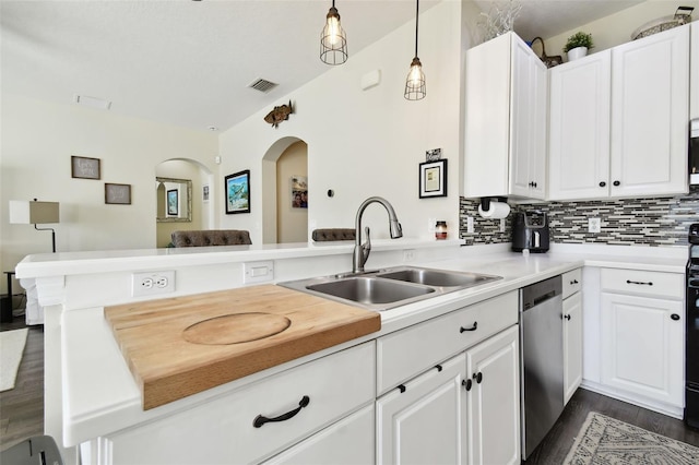 kitchen with kitchen peninsula, hanging light fixtures, sink, and stainless steel dishwasher