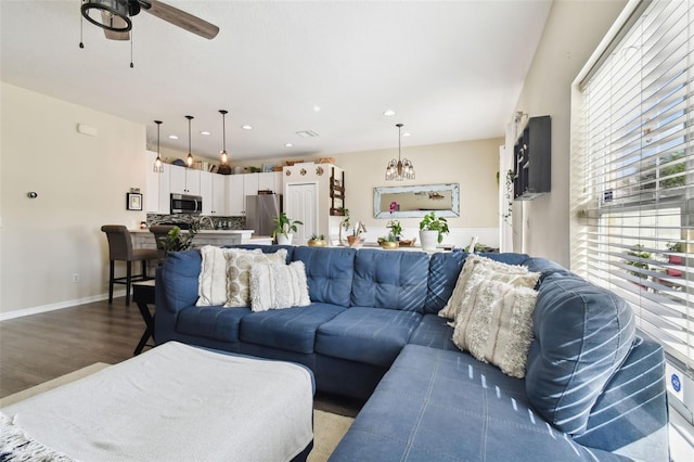 living room with sink, hardwood / wood-style floors, and ceiling fan