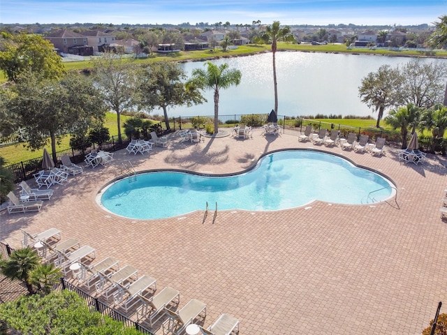 view of pool with a water view and a patio area