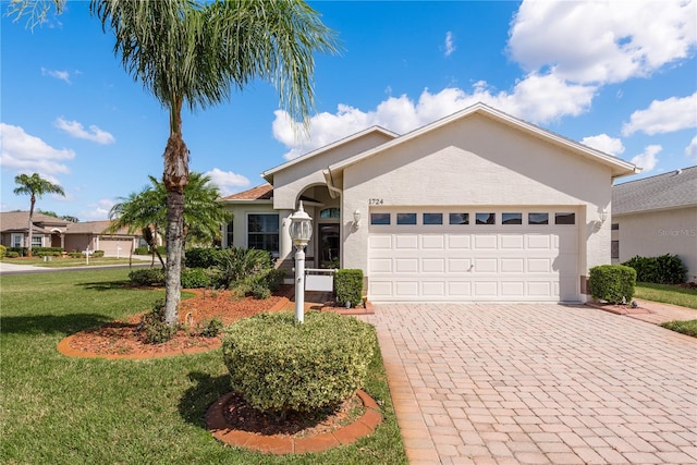 single story home with a front lawn and a garage