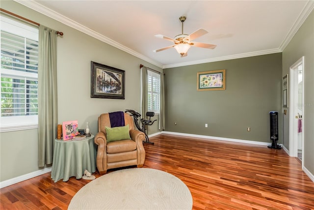 living area featuring ornamental molding, hardwood / wood-style floors, and ceiling fan