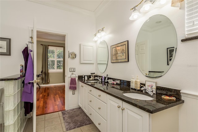 bathroom with vanity, crown molding, and tile patterned flooring