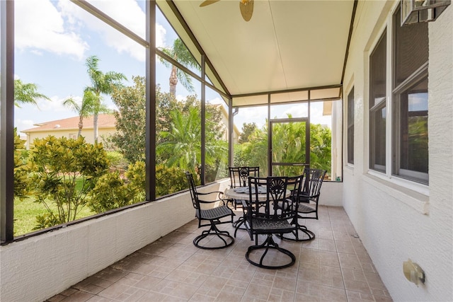 sunroom featuring lofted ceiling and ceiling fan