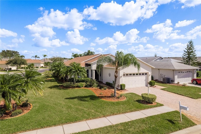 view of front of property featuring central air condition unit, a front lawn, and a garage