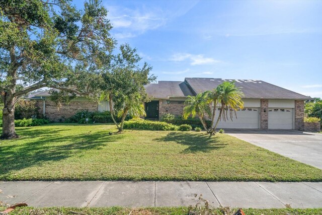 view of front of house with a front yard and a garage