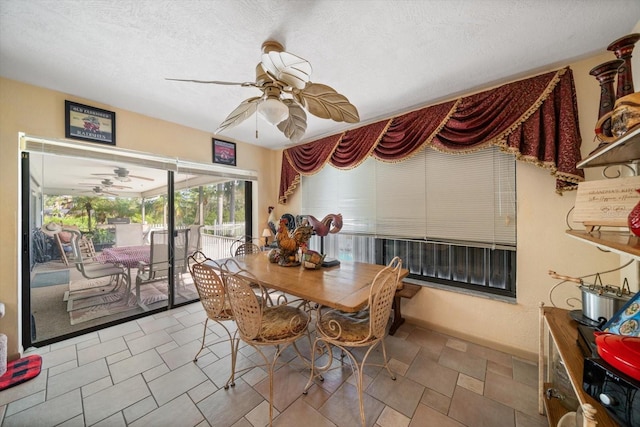 dining space featuring a textured ceiling and ceiling fan