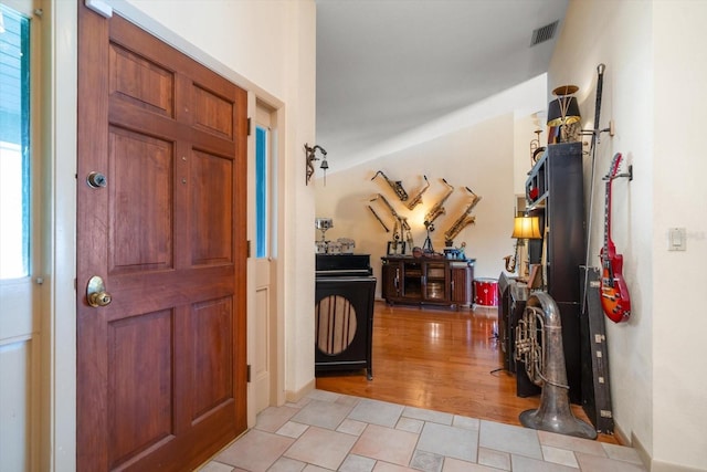 foyer entrance with a healthy amount of sunlight and light hardwood / wood-style flooring