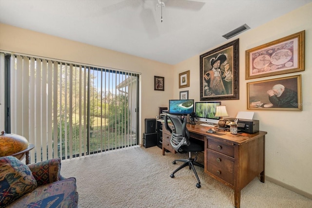 carpeted home office featuring ceiling fan