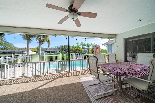 view of swimming pool with a patio and ceiling fan