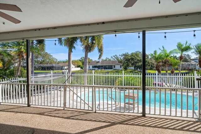 view of swimming pool with a patio and ceiling fan