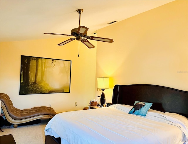 carpeted bedroom featuring ceiling fan and vaulted ceiling